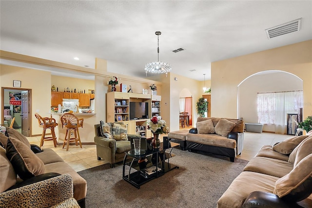 living room with light tile patterned floors and a chandelier