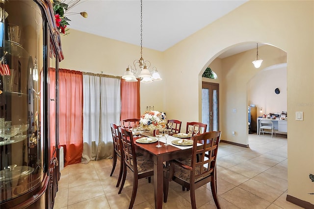 tiled dining area with a chandelier