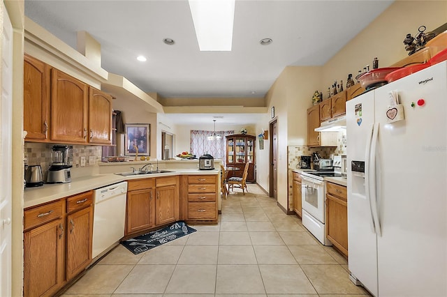 kitchen with sink, kitchen peninsula, pendant lighting, white appliances, and light tile patterned flooring