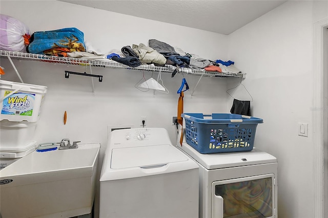 washroom featuring sink and washer and dryer