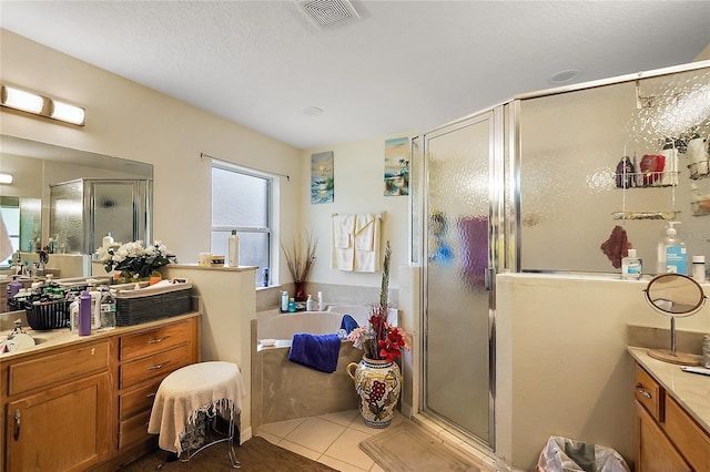 bathroom featuring tile patterned floors, vanity, and independent shower and bath