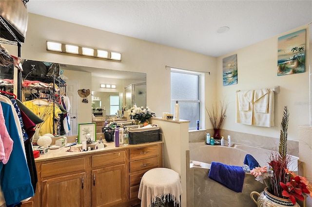 bathroom featuring plus walk in shower and vanity