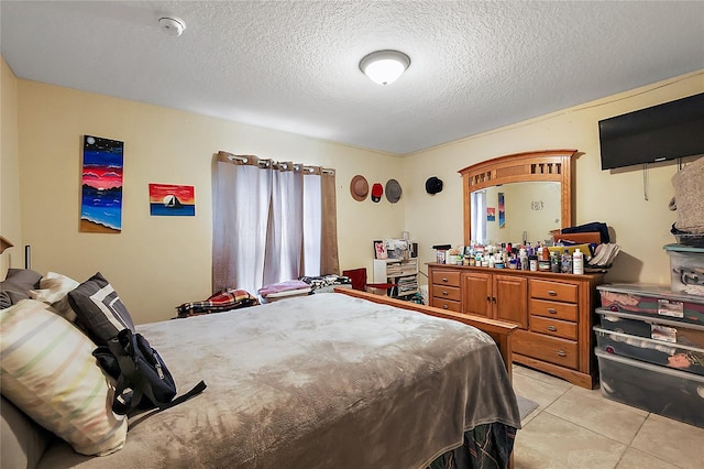 tiled bedroom featuring a textured ceiling