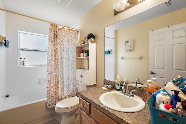 full bathroom featuring shower / bath combo with shower curtain, vanity, and toilet