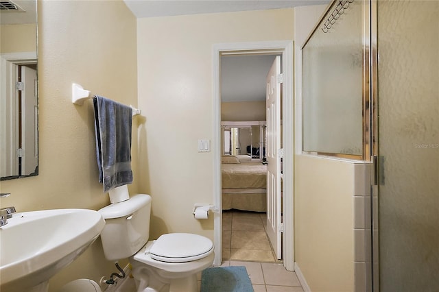 bathroom with tile patterned floors, toilet, an enclosed shower, and sink