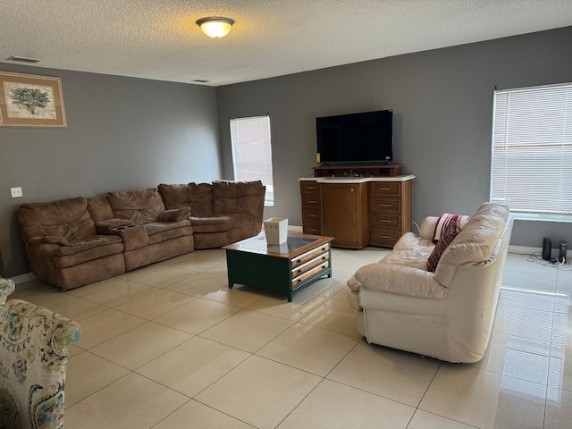 living room featuring light tile patterned floors and a textured ceiling