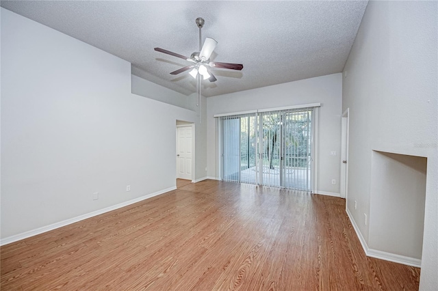 unfurnished room featuring ceiling fan, a textured ceiling, and light wood-type flooring