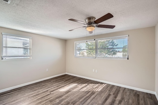 spare room featuring ceiling fan, a healthy amount of sunlight, and a textured ceiling