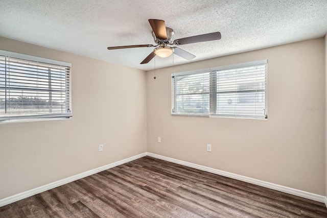 unfurnished room featuring ceiling fan, dark hardwood / wood-style flooring, and a textured ceiling