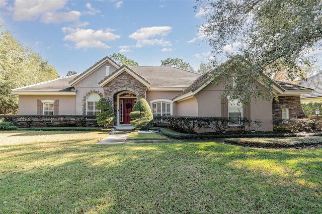 single story home featuring a front lawn