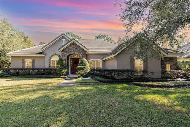 ranch-style house with a lawn