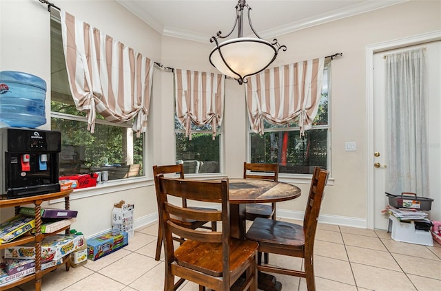 tiled dining area featuring plenty of natural light and ornamental molding