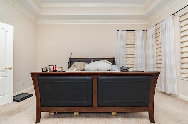 bedroom with light carpet and a tray ceiling