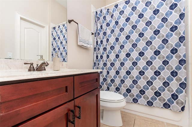 bathroom with tile patterned floors, vanity, and toilet