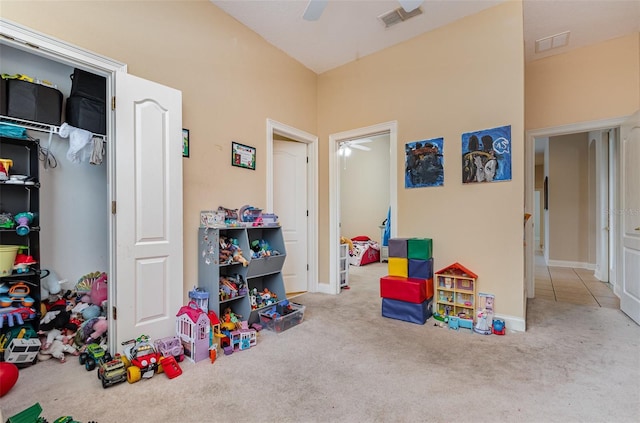 game room with ceiling fan and light carpet