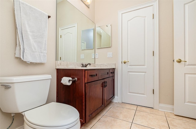 bathroom featuring tile patterned flooring, vanity, and toilet