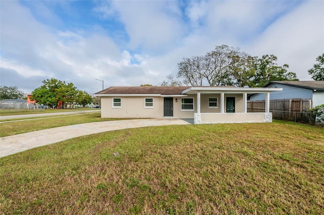 ranch-style home featuring a front yard