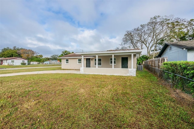 back of property featuring a lawn and central AC unit