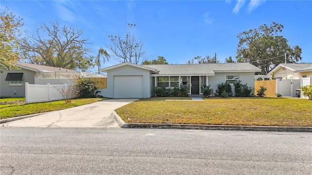 ranch-style home with a garage and a front lawn