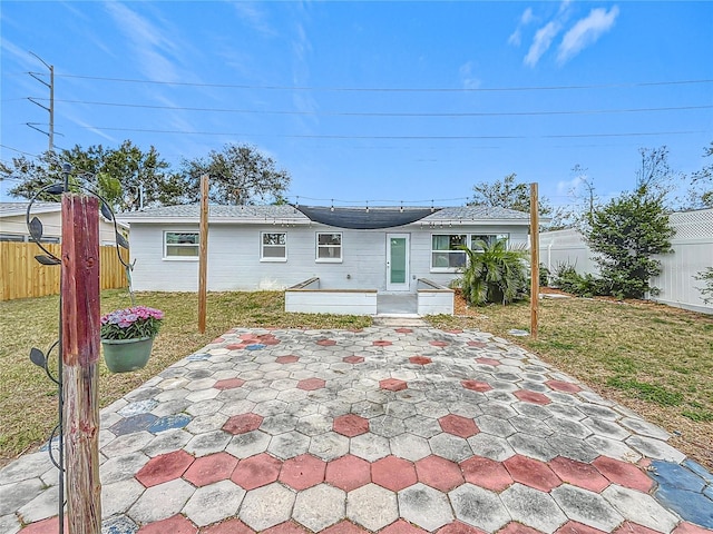 rear view of house with a patio area and a lawn