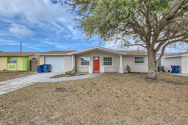 ranch-style house with a porch, a garage, and central AC unit