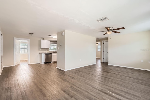 unfurnished living room with ceiling fan, dark wood-type flooring, and sink