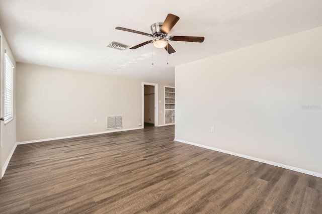 unfurnished room featuring ceiling fan and dark hardwood / wood-style floors