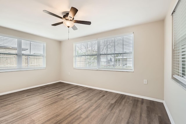 spare room featuring dark hardwood / wood-style floors and ceiling fan