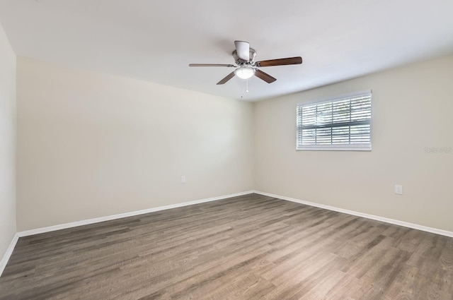 spare room with hardwood / wood-style flooring and ceiling fan