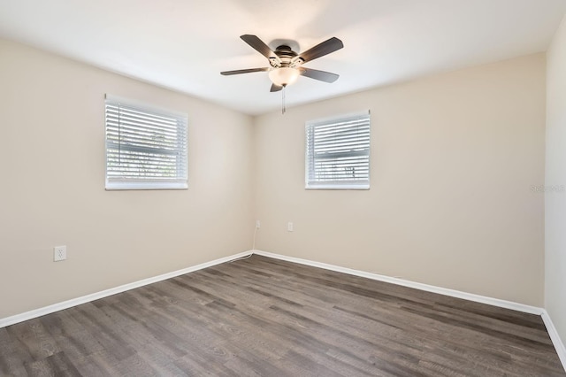 spare room featuring ceiling fan, plenty of natural light, and dark hardwood / wood-style flooring