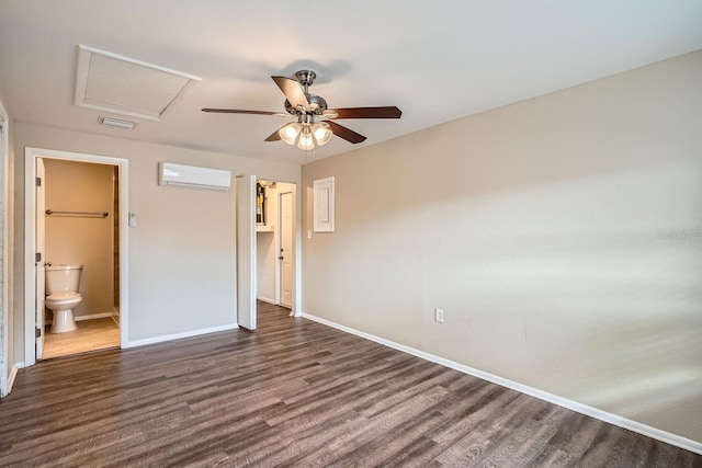 unfurnished bedroom with ceiling fan, dark hardwood / wood-style flooring, ensuite bath, and a wall mounted AC