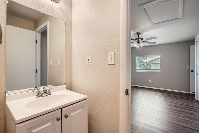 bathroom with hardwood / wood-style floors, vanity, and ceiling fan