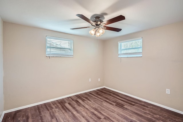 spare room featuring dark hardwood / wood-style floors, a healthy amount of sunlight, and ceiling fan