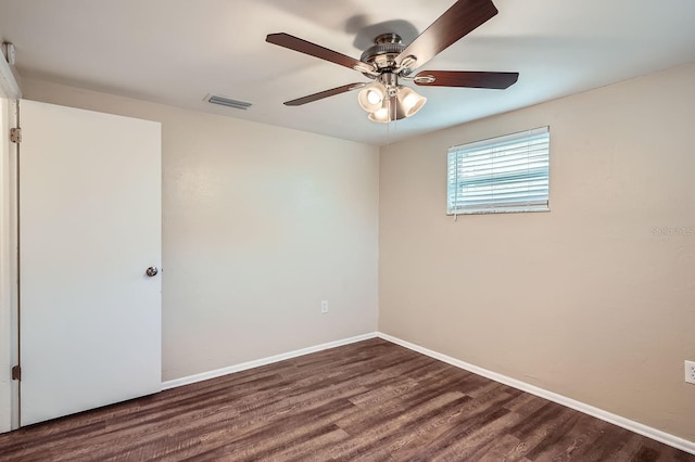 unfurnished room with ceiling fan and dark wood-type flooring