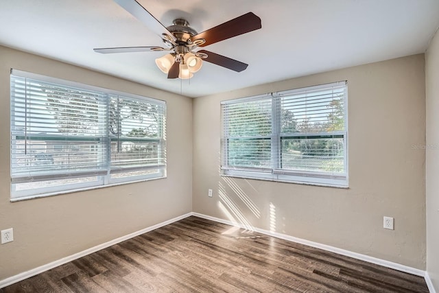 empty room with ceiling fan and dark wood-type flooring