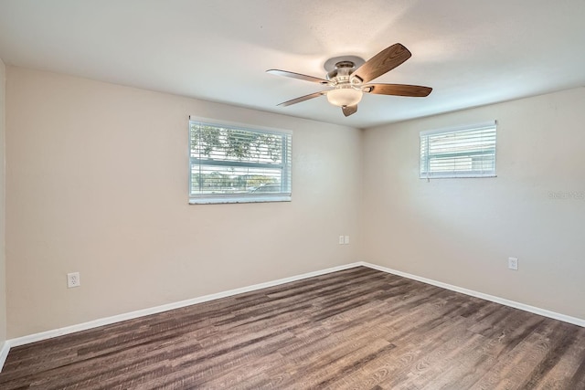 empty room featuring ceiling fan and dark hardwood / wood-style floors