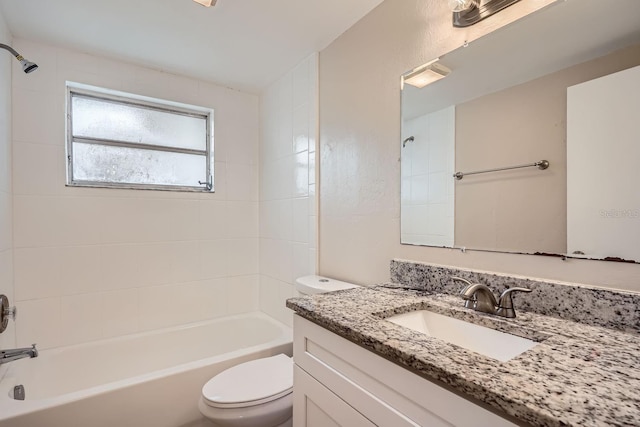 full bathroom with vanity, toilet, and tiled shower / bath combo