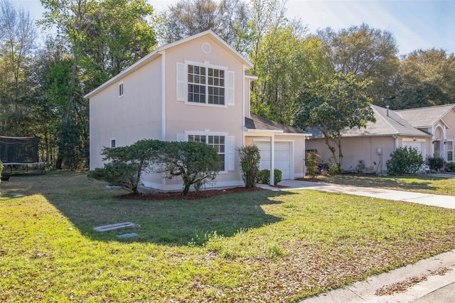 traditional-style home featuring driveway, an attached garage, a trampoline, and a front yard