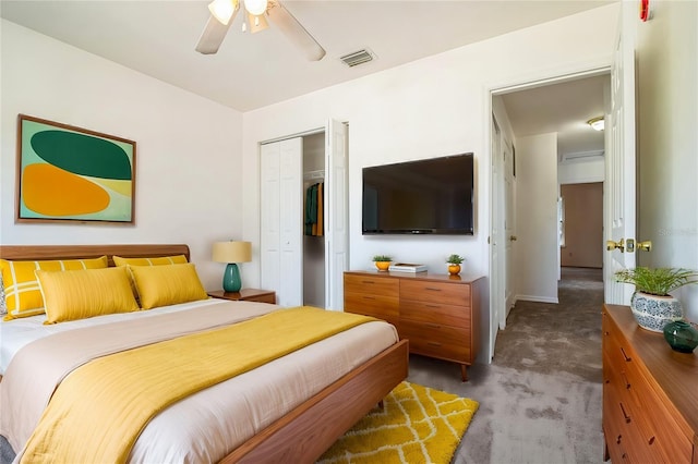 carpeted bedroom featuring a closet, visible vents, and ceiling fan