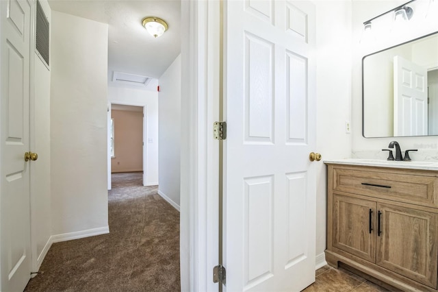 bathroom featuring visible vents, baseboards, and vanity