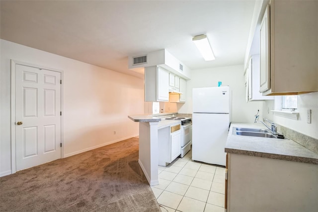 kitchen featuring visible vents, a sink, white appliances, light tile patterned flooring, and light colored carpet