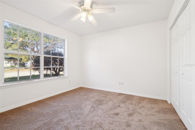 unfurnished bedroom with a closet, baseboards, and carpet