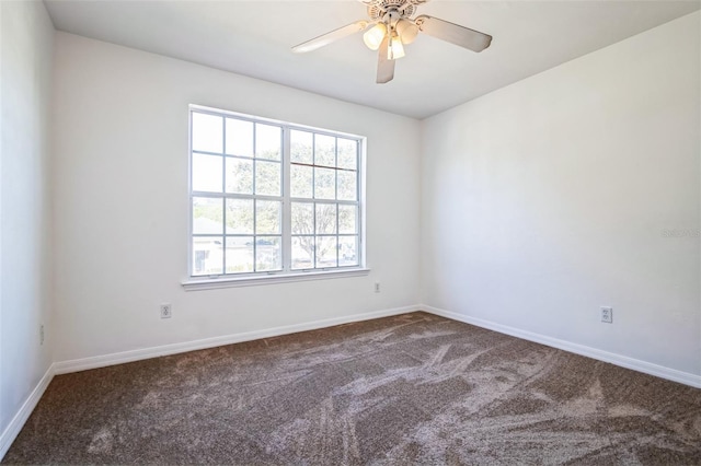 carpeted empty room with baseboards and ceiling fan