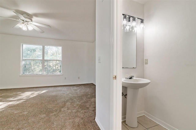 bathroom with ceiling fan, baseboards, and a sink