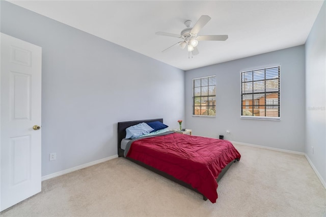 bedroom with light colored carpet and ceiling fan