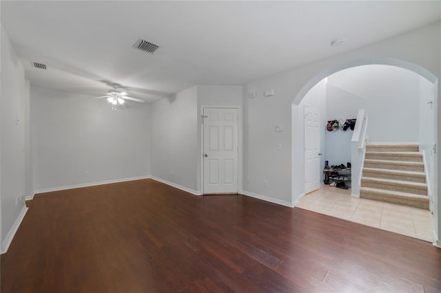 empty room with ceiling fan and hardwood / wood-style floors