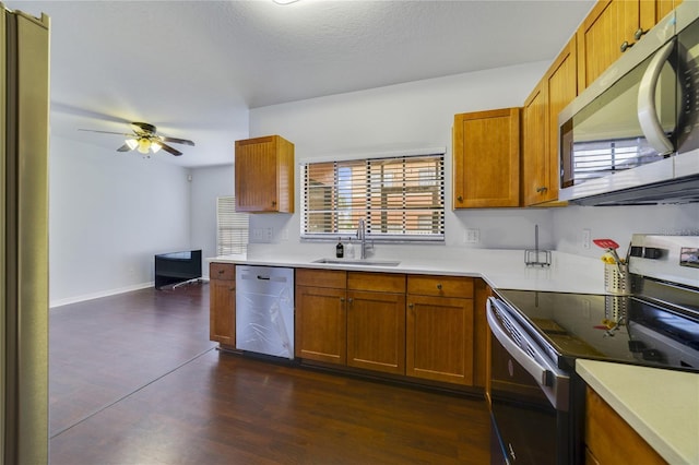 kitchen featuring ceiling fan, sink, dark hardwood / wood-style floors, and appliances with stainless steel finishes