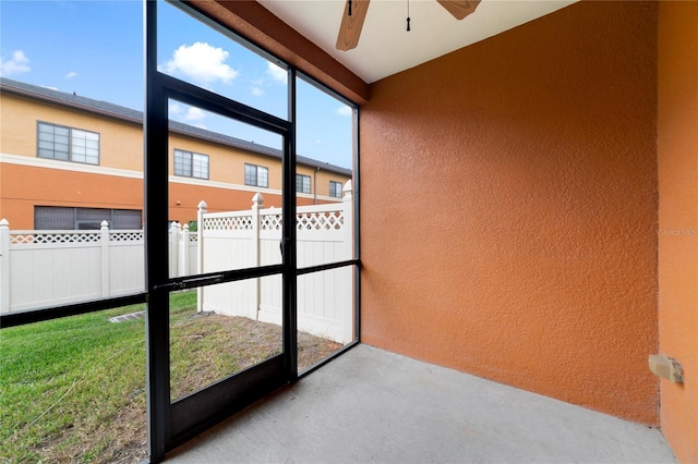 unfurnished sunroom with a wealth of natural light and ceiling fan