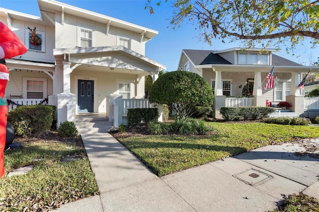 bungalow-style home with covered porch and a front lawn