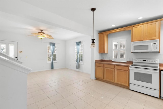 kitchen featuring ceiling fan, white appliances, hanging light fixtures, and light tile patterned floors